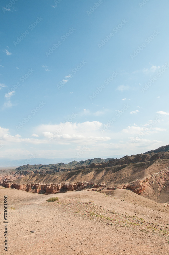 Charyn canyon or the Grand canyon located in the Almaty region of Kazakhstan, vertical shot with blue sky Charyn canyon or the Grand canyon located in the Almaty region of Kazakhstan, vertical shot with blue sky