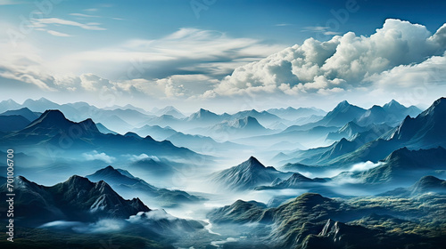 Clouds Above the Jagged Peaks of a Blue Mountain Landscape with Misty Valleys © Frank
