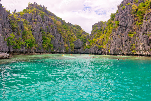 PALAWAN, PHILIPPINES - DECEMBER 21, 2023: Blue lagoon tropical landscape at the Coron island bay in Palawan province Philippines. 6 million foreign tourists visited Philippines in 2016.
