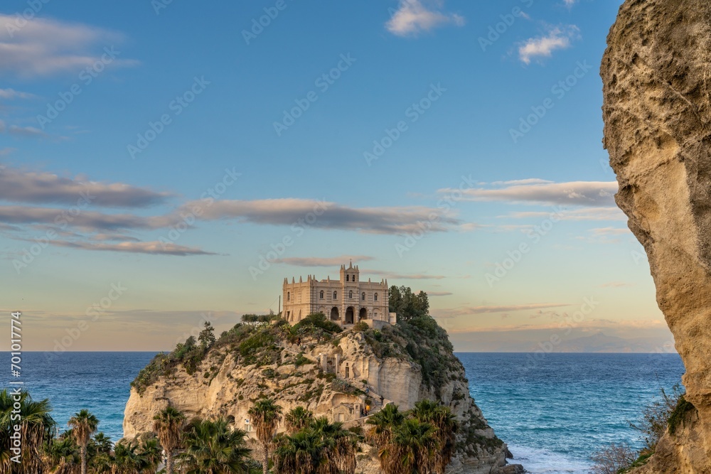 view of the Santa Maria dell'Isola Church on its rocky promontory in Tropea at sunset