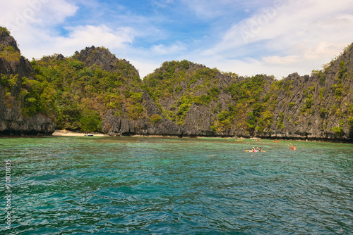 PALAWAN, PHILIPPINES - DECEMBER 21, 2023: Blue lagoon tropical landscape at the Coron island bay in Palawan province Philippines. 6 million foreign tourists visited Philippines in 2016.