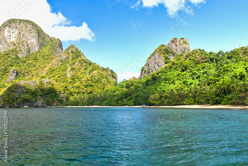 PALAWAN, PHILIPPINES - DECEMBER 21, 2023: Local traditional outrigger tour boat with tropical islands in El Nido on Palawan Island in the Philippines. 6 million tourists visited Philippines in 2016. 