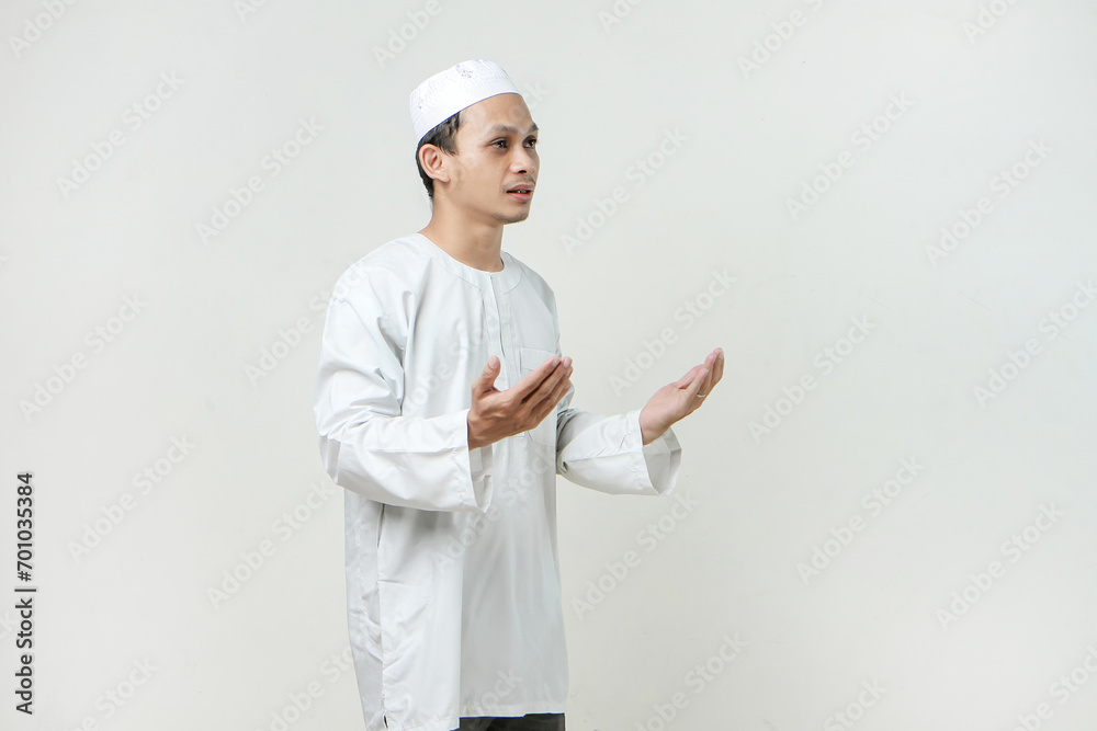 asian muslim man with praying hand gesture. holding palm face up. People religious Islam lifestyle concept. celebration Ramadan and ied Mubarak. on isolated background. asian muslim man with praying hand gesture. holding palm face up. People religious Islam lifestyle concept. celebration Ramadan and ied Mubarak. on isolated background.