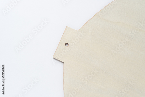 thin plywood sheet with clean, geometric laser cut edges and peg hole on white paper