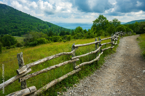 A long wooden fence along a worn trail in a mountain meadow in Grayson Highlands State Park, Virginia photo