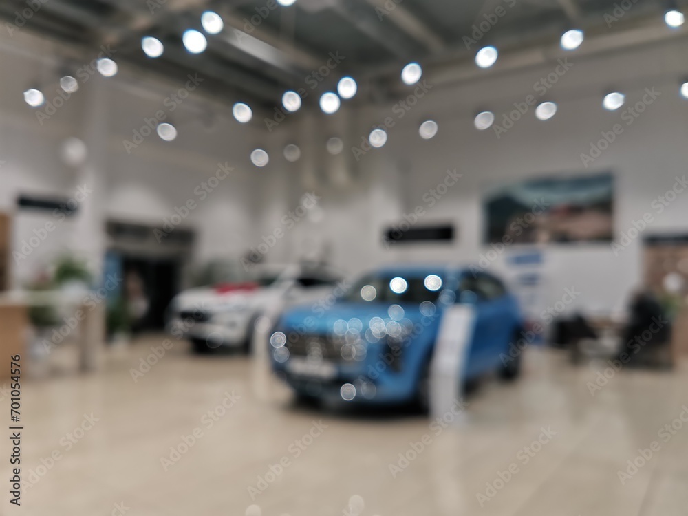 Blurred new car parked in modern showroom waiting for sales.