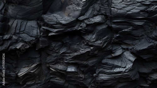 Black obsidian rock texture background, natural wave patterns in a stone, dark stone with cracks, dark stone texture