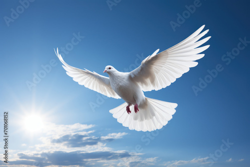 A dove in flight against a clear blue sky, representing the universal symbol of peace and freedom. Generative Ai. © Sebastian