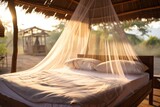 A outdoor bed draped with a mosquito net, inviting relaxation amidst a serene natural setting. Malaria protection concept 