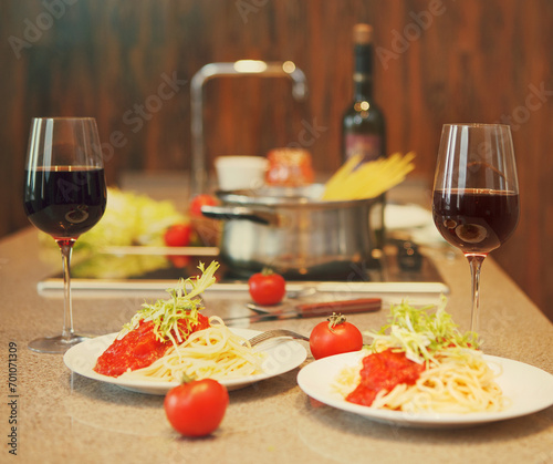 Spaghetti with tomato sauce and red wine in a kitchen photo