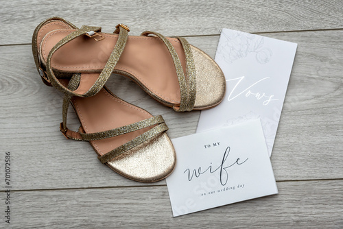 The bride's gold wedding shoes with her wedding vow card and a card from her future husband.