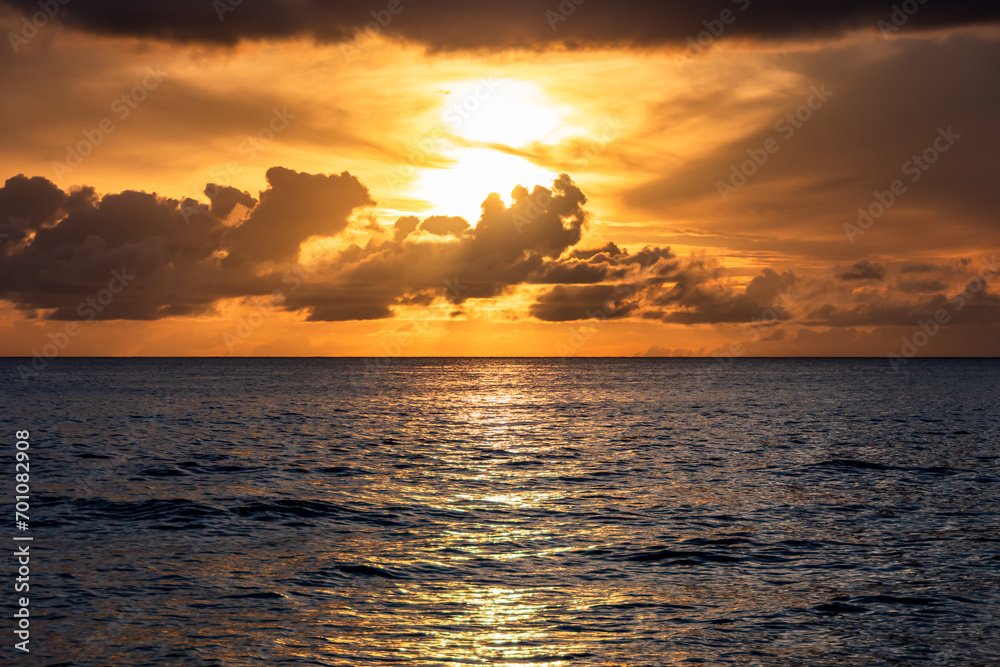 Fototapeta premium Paynes Bay Beach, Barbados: boats sailing during an amazing colorful sunset in the caribbean sea.