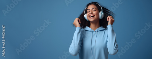 African American teenager young woman with headphone listen to music with happiness, World hearing day. photo