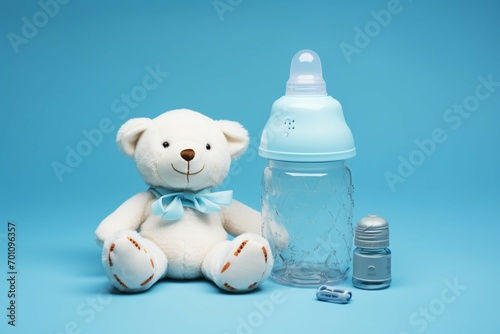 Baby essentials on blue canvas pacifier, bottle, cap, copy space.