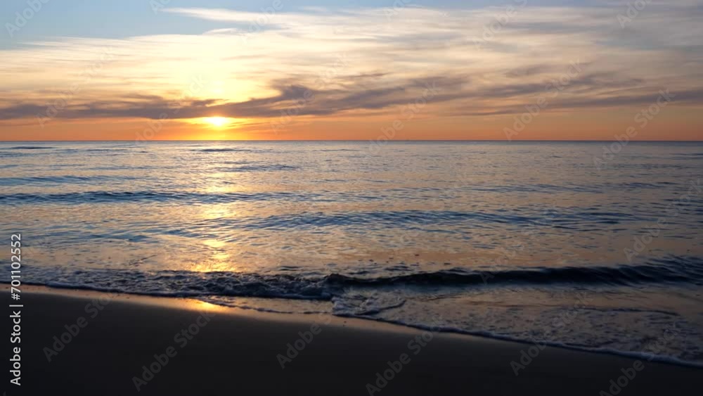 Sunset at Baltic sea in Lithuania's seaside resort Palanga. Sun just above horizon line on the left side of frame. Sunset at Baltic sea in Lithuania's seaside resort Palanga. Sun just above horizon line on the left side of frame.