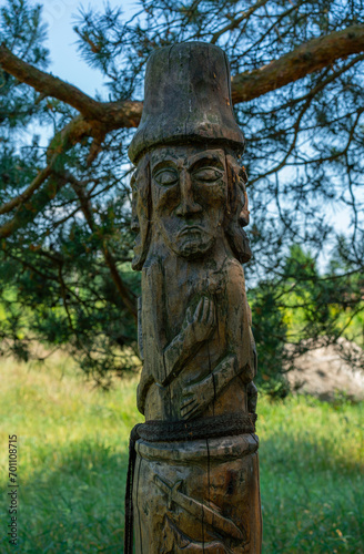 wooden pagan slavic gods totem pole - ancient monument folk ritual symbol in forest © FilipB