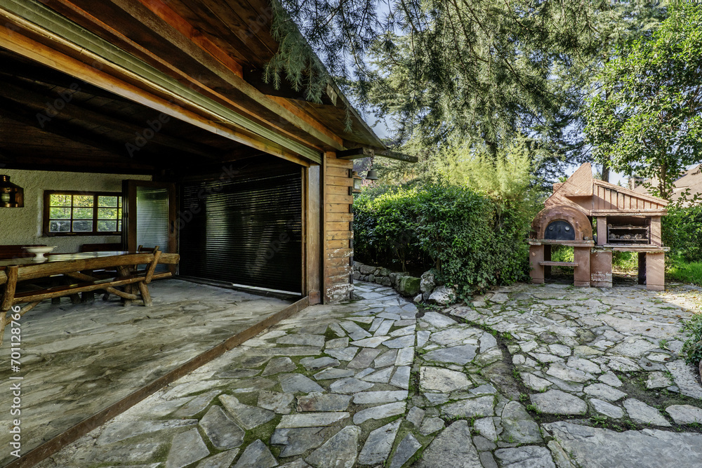 A large garden shed with rustic wooden furniture, a drinks bar, quirky decorative details, liftgates and outdoor grills A large garden shed with rustic wooden furniture, a drinks bar, quirky decorative details, liftgates and outdoor grills