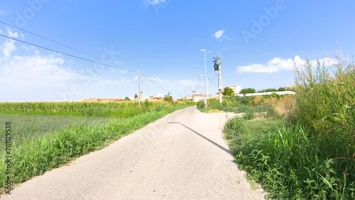 a paved road through agricultural fields entering Boldu village, municipality of La Fuliola, comarca of Urgel, Province of Lleida, Catalonia, Spain photo