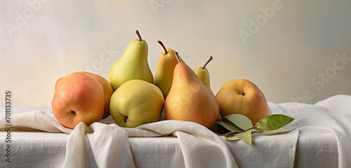 A delightful setup of Anjou pears, Bartlett pears, and Bosc pears on a pastel sky grey cloth photo