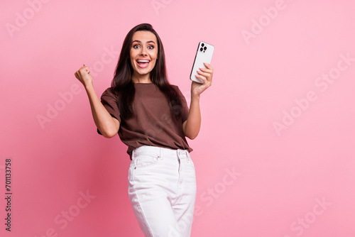 Photo of young overjoyed funny woman celebrate betting awesome victory slotoking online casino advert isolated on pink color background