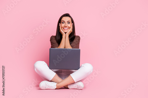 Full length photo of woman amazed touch cheeks overjoyed reaction happy emotions new laptop surprise isolated on pink color background