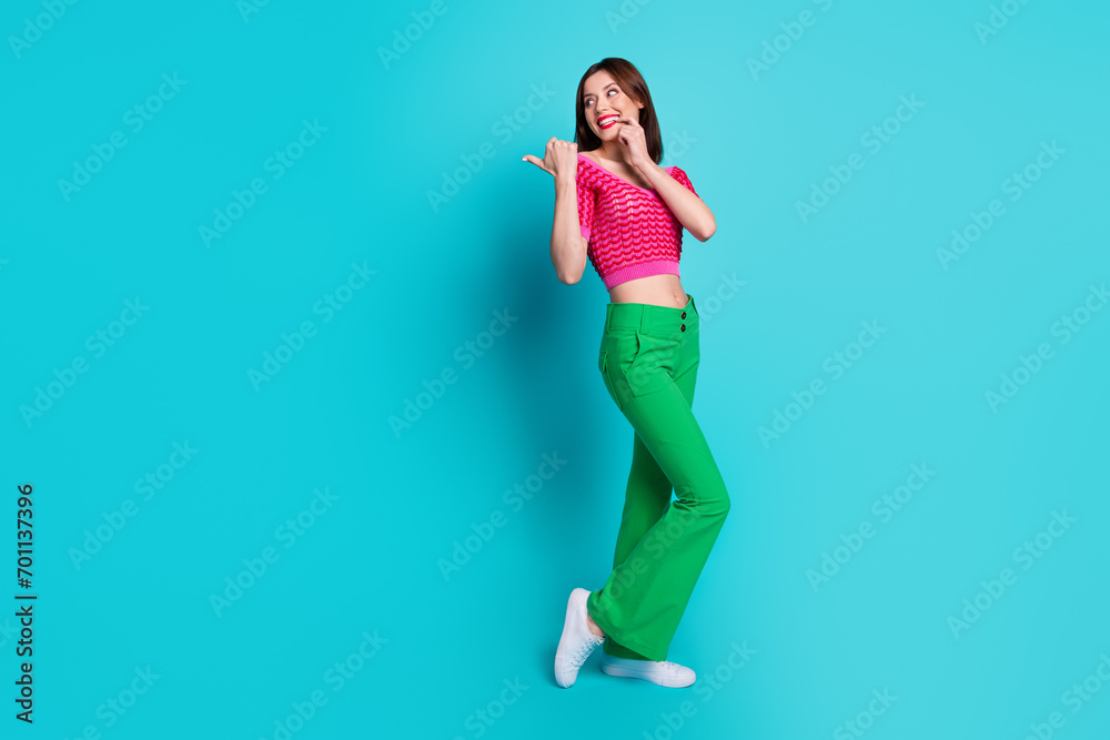 Photo of promoter girl demonstrate empty space bargain sale discount promo isolated over blue color background Photo of promoter girl demonstrate empty space bargain sale discount promo isolated over blue color background