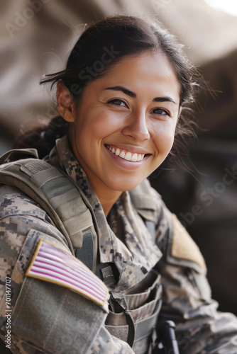 Hispanic woman wearing army universal camouflage uniform smiling photo