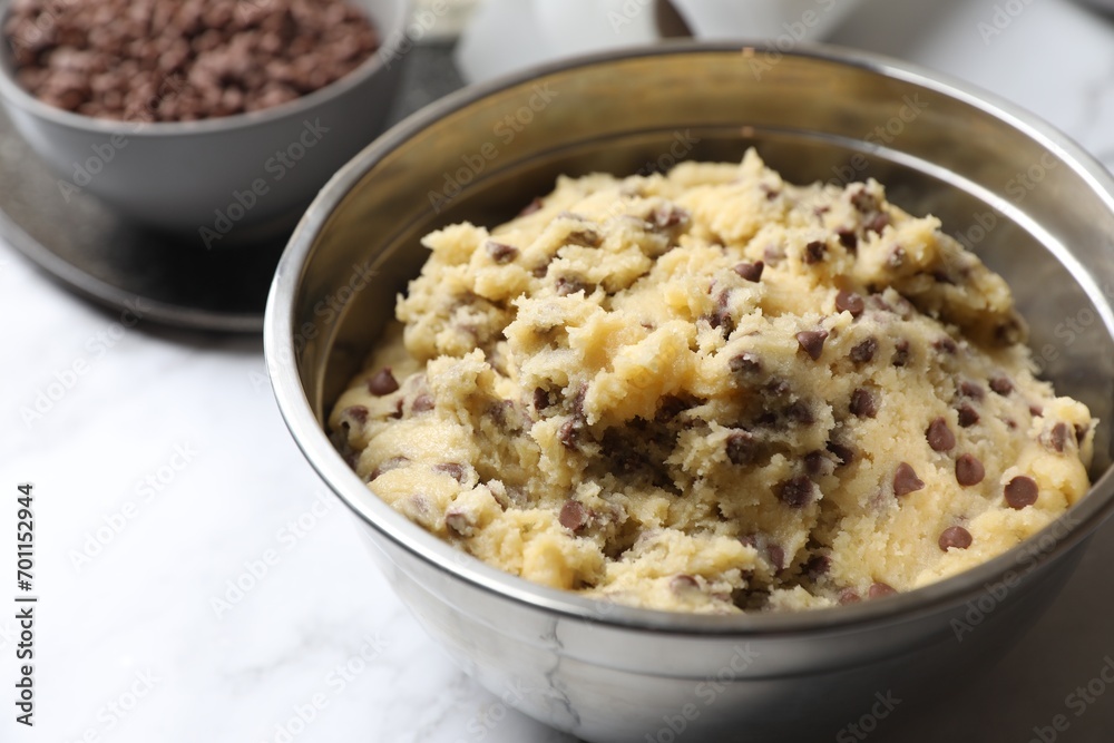 Chocolate chip cookie dough in bowl on table, closeup Chocolate chip cookie dough in bowl on table, closeup