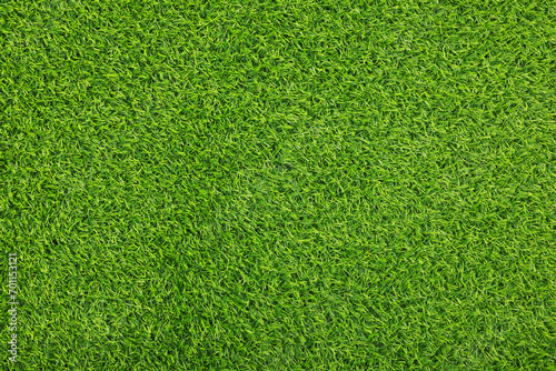 Green artificial grass as background, top view