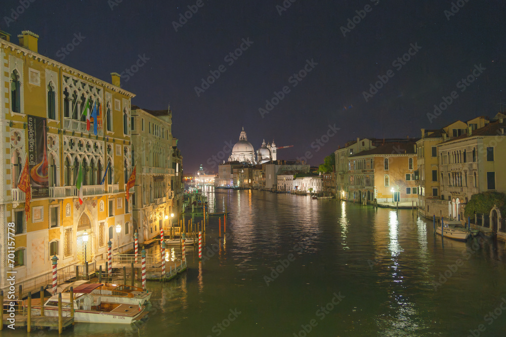 Night View along Grand Canal  past buildings and piers to domes of St Mark's