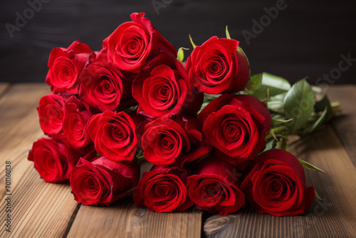 A dozen red roses  Valentine s Day gift isolated on a wooden table top