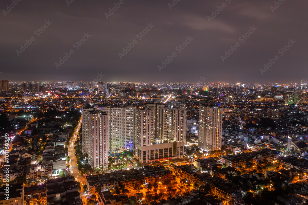 Big city urban sprawl at night and illuminated from aerial view.
