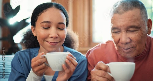 Coffee, relax or visit with a nurse and patient on a sofa in the living room of a home for assisted living. Face, tea or charity with a woman volunteer and senior man in an apartment for retirement photo