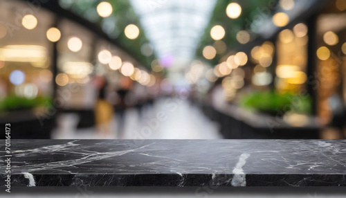 Empty black marble stone table top on blurred with bokeh shopping mall and restaurant background - can be used for display or montage your products