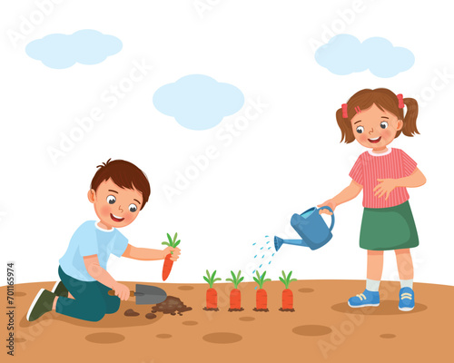 Cute kids planting and watering carrots in the garden