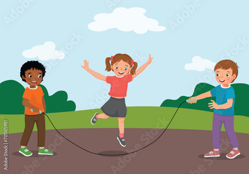 Cute little kids children boy and girl playing jumping rope at the park
