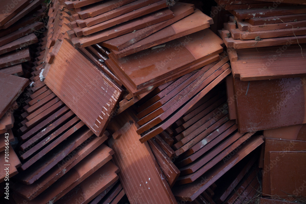 A pile of roof tiles in a construction site, closeup of photo - obrazy, fototapety, plakaty 