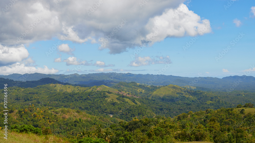 panoramic view of a tropical island, mountains, forest, clouds
