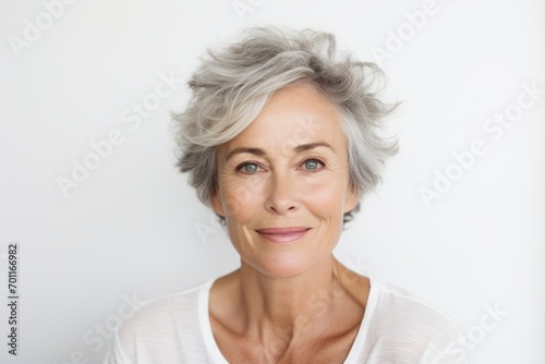 Portrait of a happy senior woman looking at the camera over white background