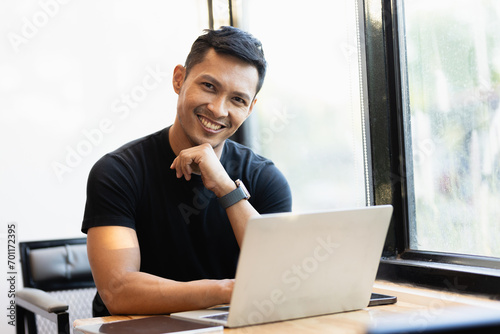 Startup successful small business owner sme beauty girl stand with tablet smartphone in coffee shop restaurant. Portrait of asian tan woman barista cafe owner. SME entrepreneur seller business concept