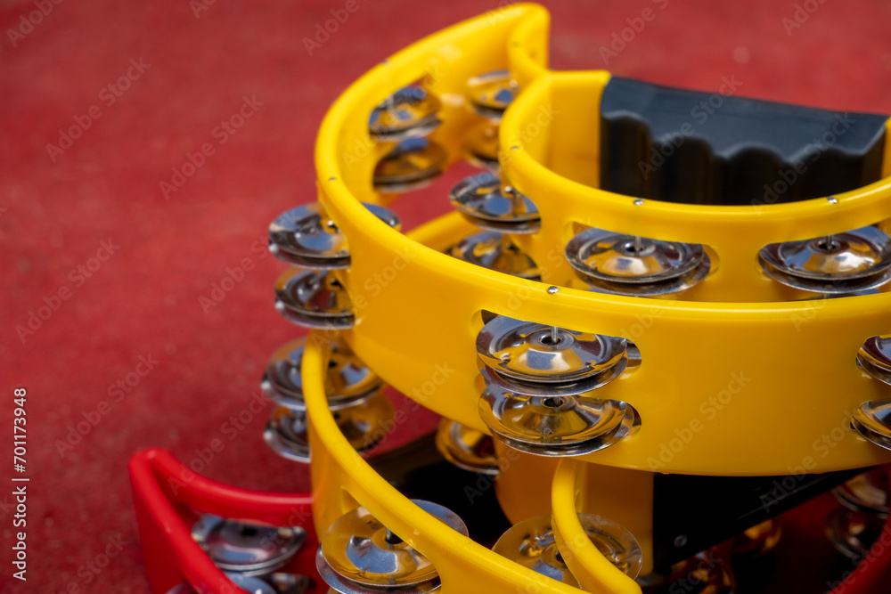 stack of tambourine musical instruments on a red background