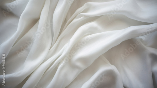 A close-up of the delicate texture of white silky fabric, highlighting its elegance and smoothness.