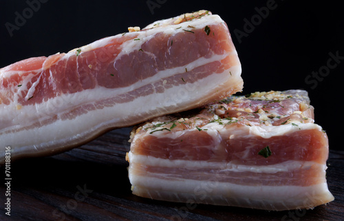 Appetizing salty lard with layers of meat. Salted lard with garlic and herbs.