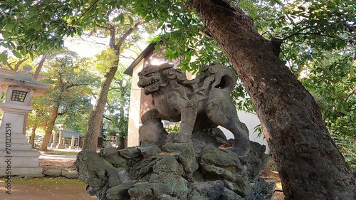Komainu (guardian dogs) sun light shrine precincts stone statue rock stone Minato-ku, Tokyo, Japan. Akasaka Hikawa Shrine