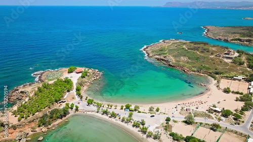 Aerial view of Stavros with turquoise water and sandy beach overlooked by craggy mountains in Crete, Greece. Drone view of Sandy Cove, an excellent spot for relaxing holidays in Greece. photo