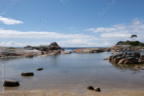 Beach with orange-hued granite rocks in the Bay of Fires on the northeastern coast of Tasmania in Australia, extending from Binalong Bay to Eddystone Point 
