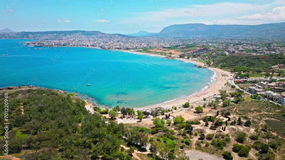 Aerial view of Iguana Beach with a short straight coastline with crystal turquoise water and bright sand. View from above of tourists enjoying summer vacation with sandy beach in Crete, Greek Island. Aerial view of Iguana Beach with a short straight coastline with crystal turquoise water and bright sand. View from above of tourists enjoying summer vacation with sandy beach in Crete, Greek Island.