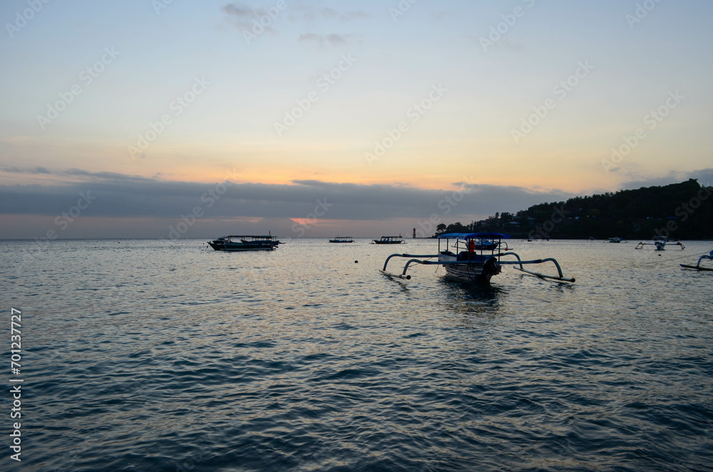 The beauty of Senggigi Beach at sunset with boats that decorate the beautiful beachfront The beauty of Senggigi Beach at sunset with boats that decorate the beautiful beachfront