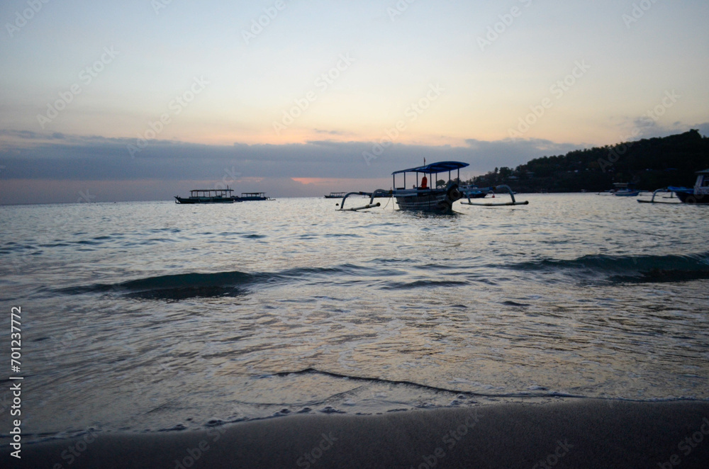 The beauty of Senggigi Beach at sunset with boats that decorate the beautiful beachfront The beauty of Senggigi Beach at sunset with boats that decorate the beautiful beachfront