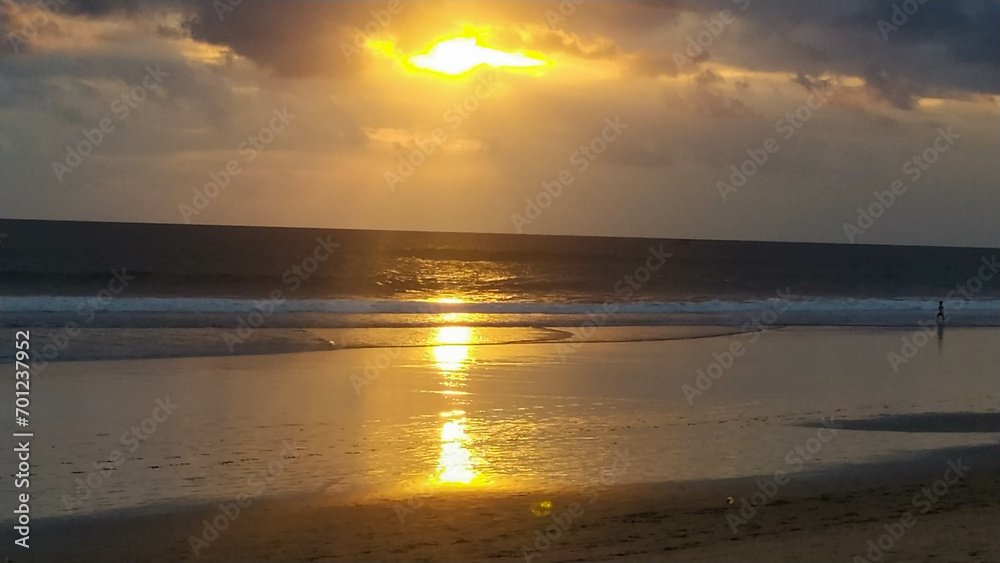 Obraz premium The view of the sunset with a beautiful sky and a boat on the beach
